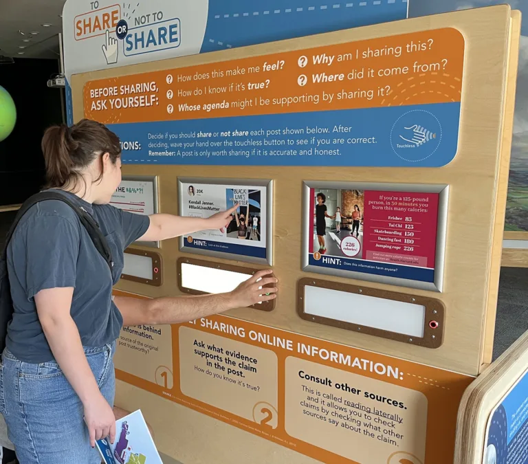 Students using To Share or Not To Share activity at Wonder Media Exhibit